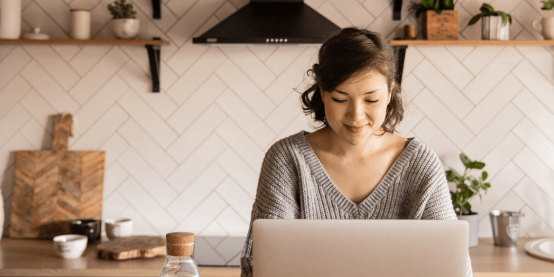 woman at laptop in kitchen